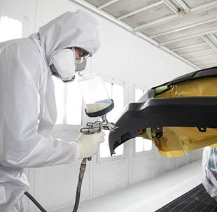 Collision Center Technician Painting a Vehicle | Toyota of Fort Worth in Fort Worth TX