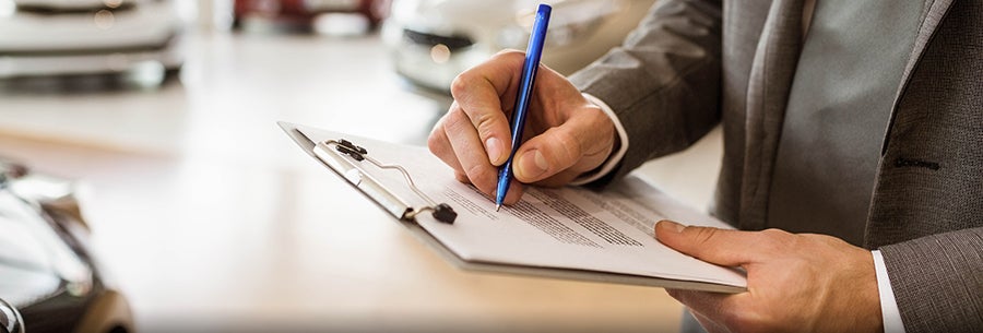 image of a person signing something on a clipboard