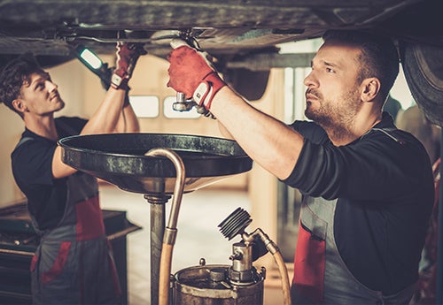 image of a 2 men doing an oil change