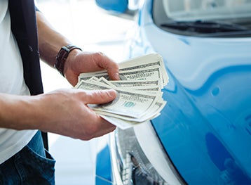 image of a man holding money