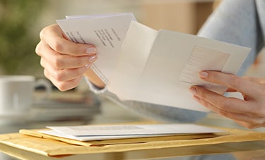 image of a person sorting through bills