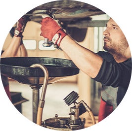 image of a mechanic doing an oil change