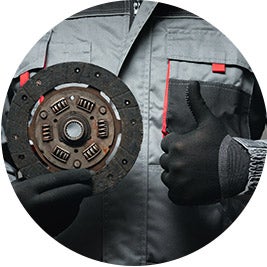 image of a person holding a car part and putting a thumbs up